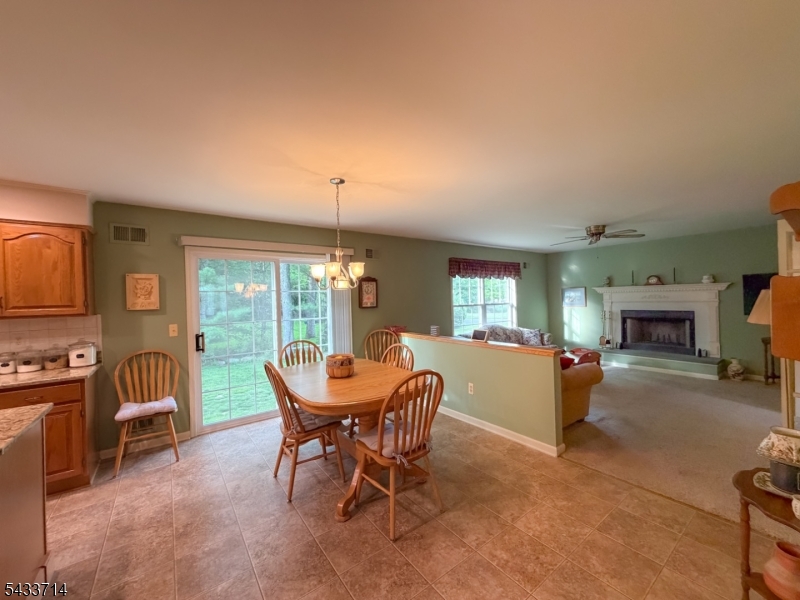 29 Lark Lane Oak Ridge, NJ 07438 - Photo 7 of 26 a living room with furniture a fireplace and a large window