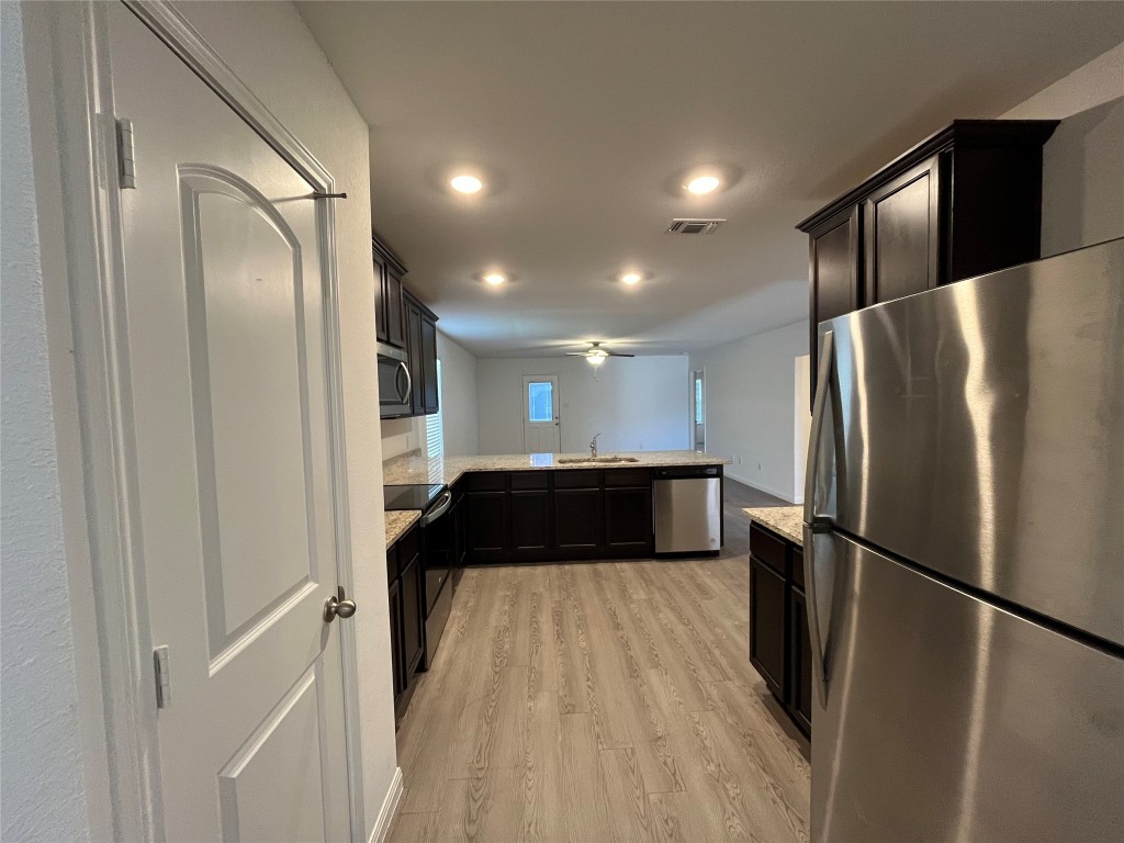 14141 Prospector Way Elgin, TX 78621 - Photo 4 of 16 Kitchen with fridge
