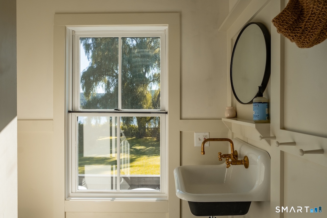 69 Mudge Pond Road Sharon, CT 06069 - Photo 13 of 28 a bathroom with a sink and a mirror