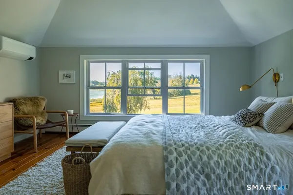 a bedroom with a bed and a chair
