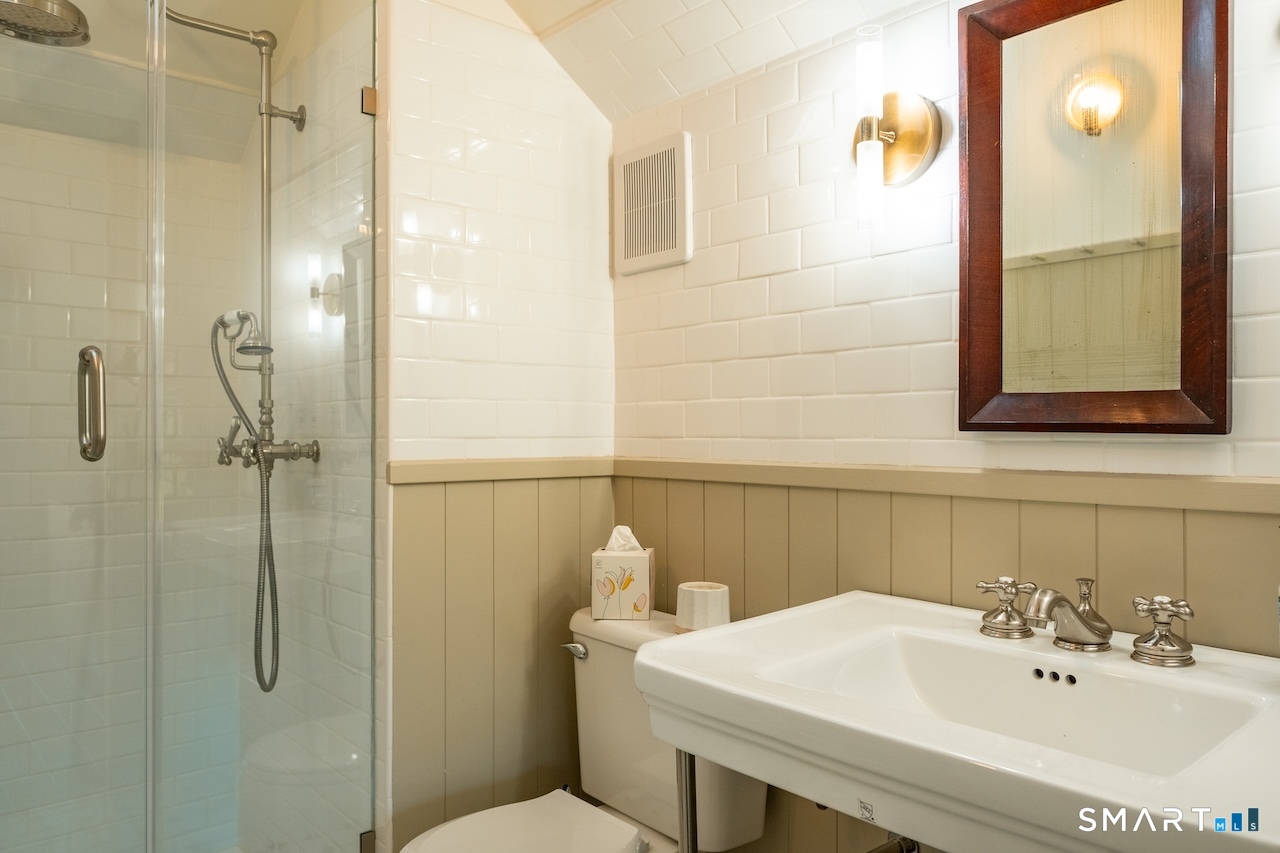 69 Mudge Pond Road Sharon, CT 06069 - Photo 18 of 28 a bathroom with a sink a toilet and shower