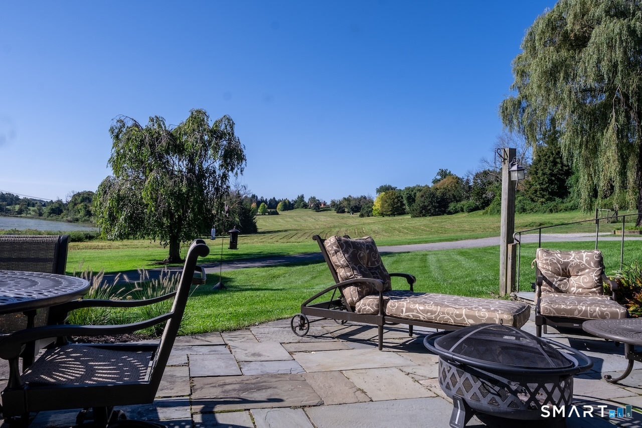 69 Mudge Pond Road Sharon, CT 06069 - Photo 20 of 28 a view of a patio with chairs and a table