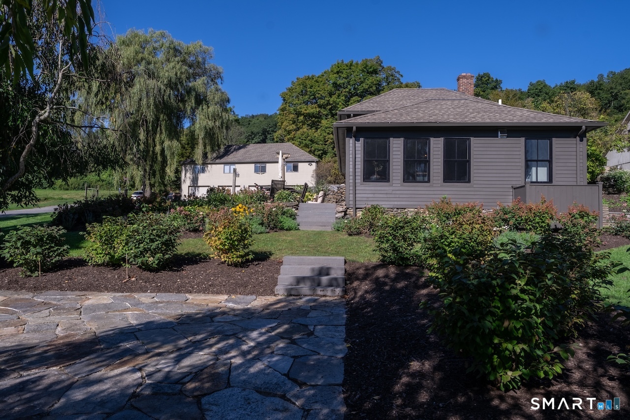 69 Mudge Pond Road Sharon, CT 06069 - Photo 26 of 28 a front view of a house with a yard