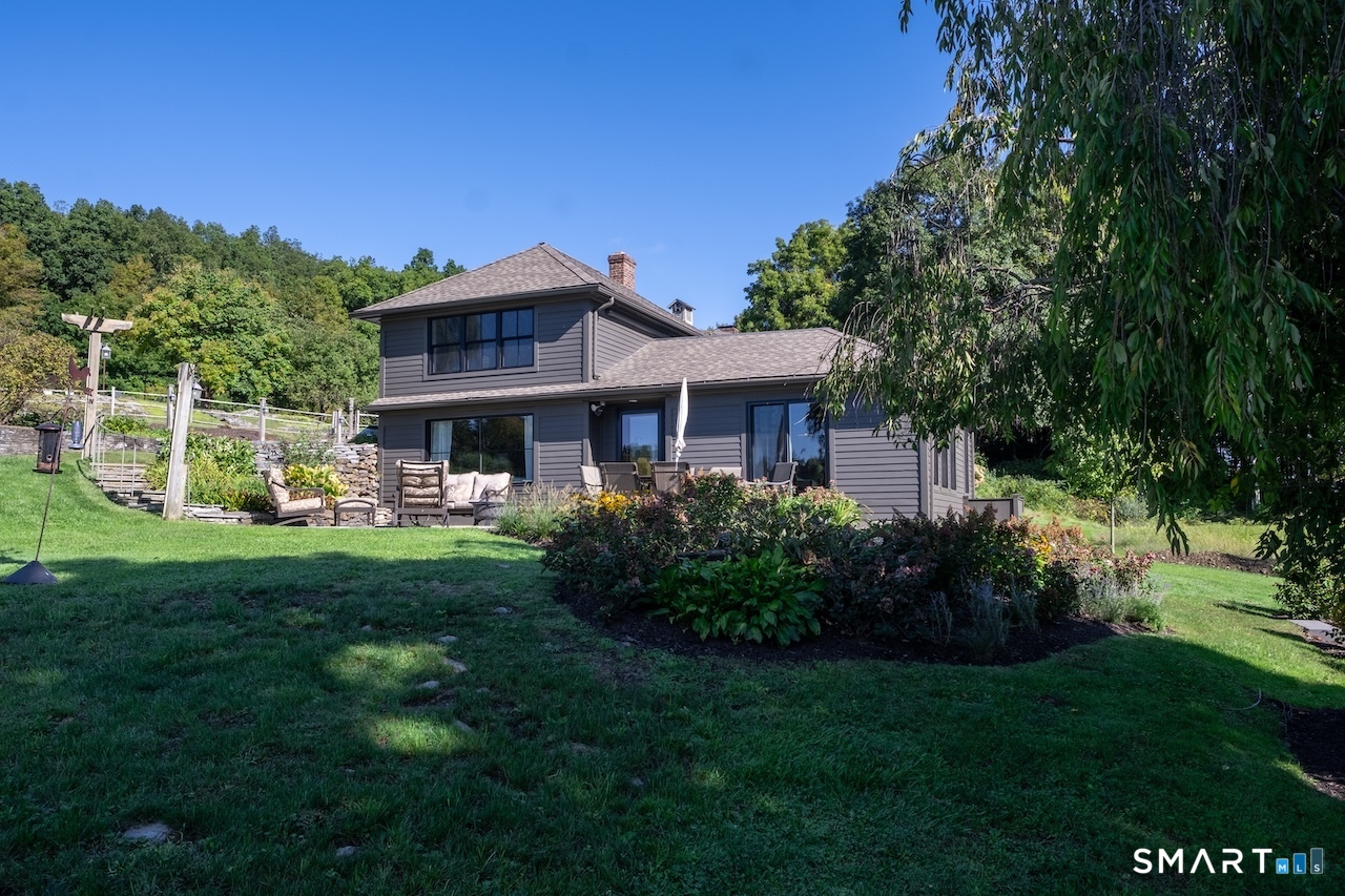 69 Mudge Pond Road Sharon, CT 06069 - Photo 28 of 28 a front view of a house with a yard