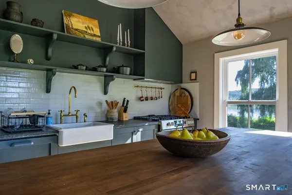 a view of a kitchen with a sink and window