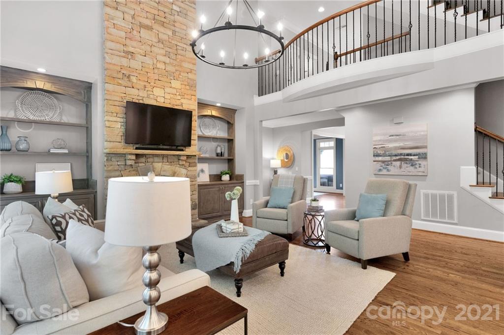 1111 Lytton Lane Matthews, NC 28104 - Photo 15 of 48 a living room with furniture a flat screen tv and kitchen view