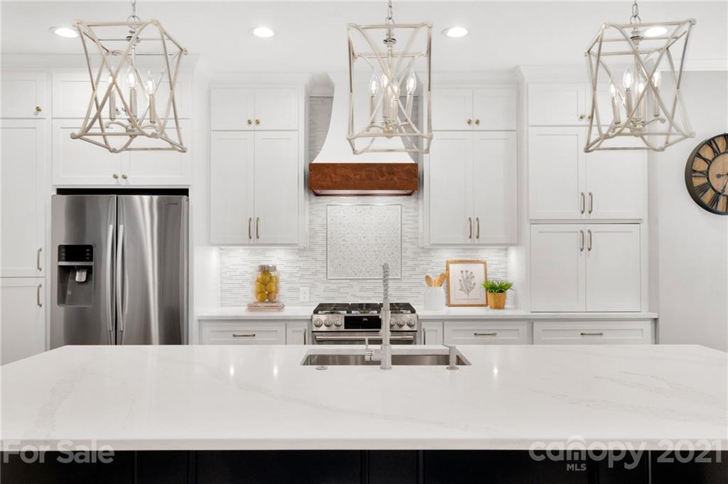 1111 Lytton Lane Matthews, NC 28104 - Photo 16 of 48 a kitchen with a sink a stove and refrigerator