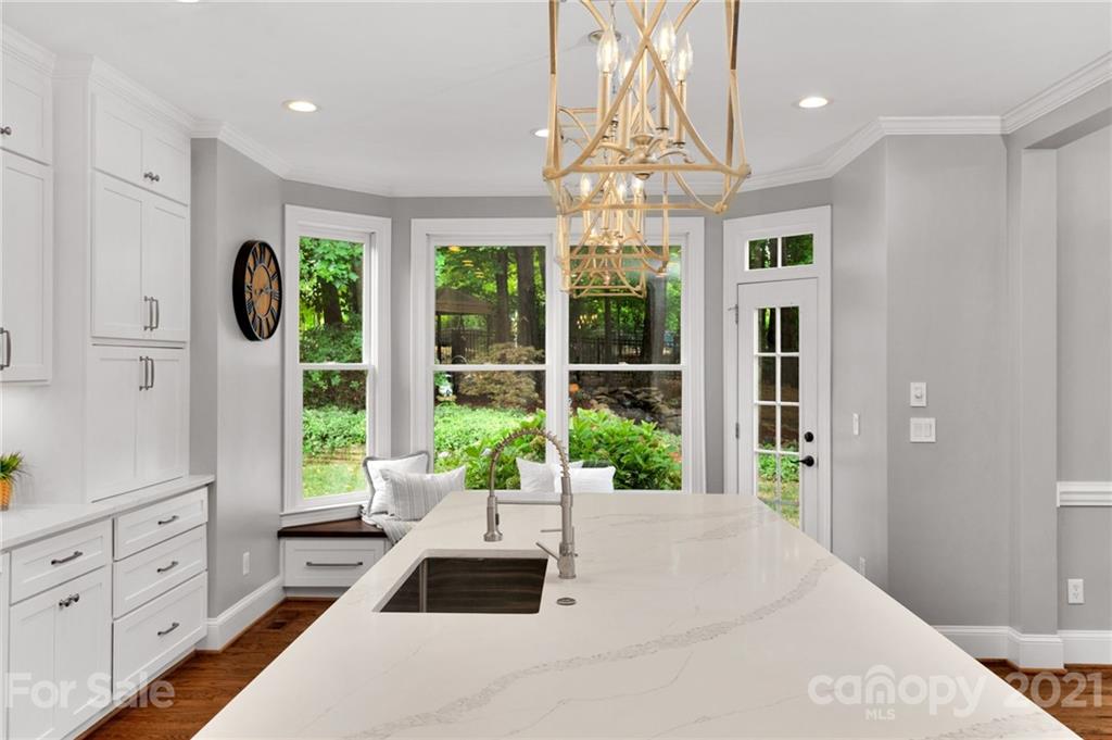 1111 Lytton Lane Matthews, NC 28104 - Photo 18 of 48 a large white room with a large window and chandelier