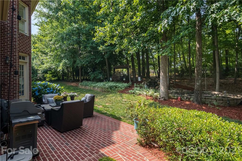 1111 Lytton Lane Matthews, NC 28104 - Photo 44 of 48 a view of a backyard with sitting area and garden