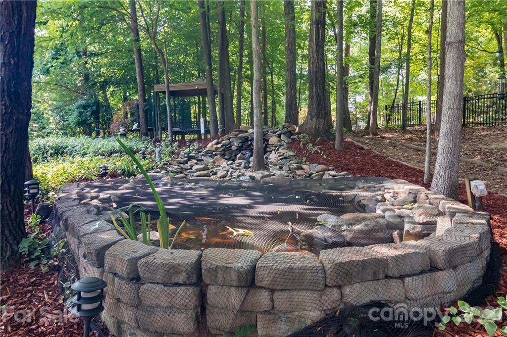 1111 Lytton Lane Matthews, NC 28104 - Photo 46 of 48 a view of a backyard with table and chairs potted plants and large tree