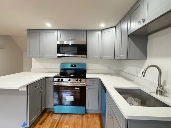 a kitchen with a stove a sink and a microwave