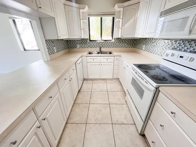 a kitchen with a sink stove and cabinets