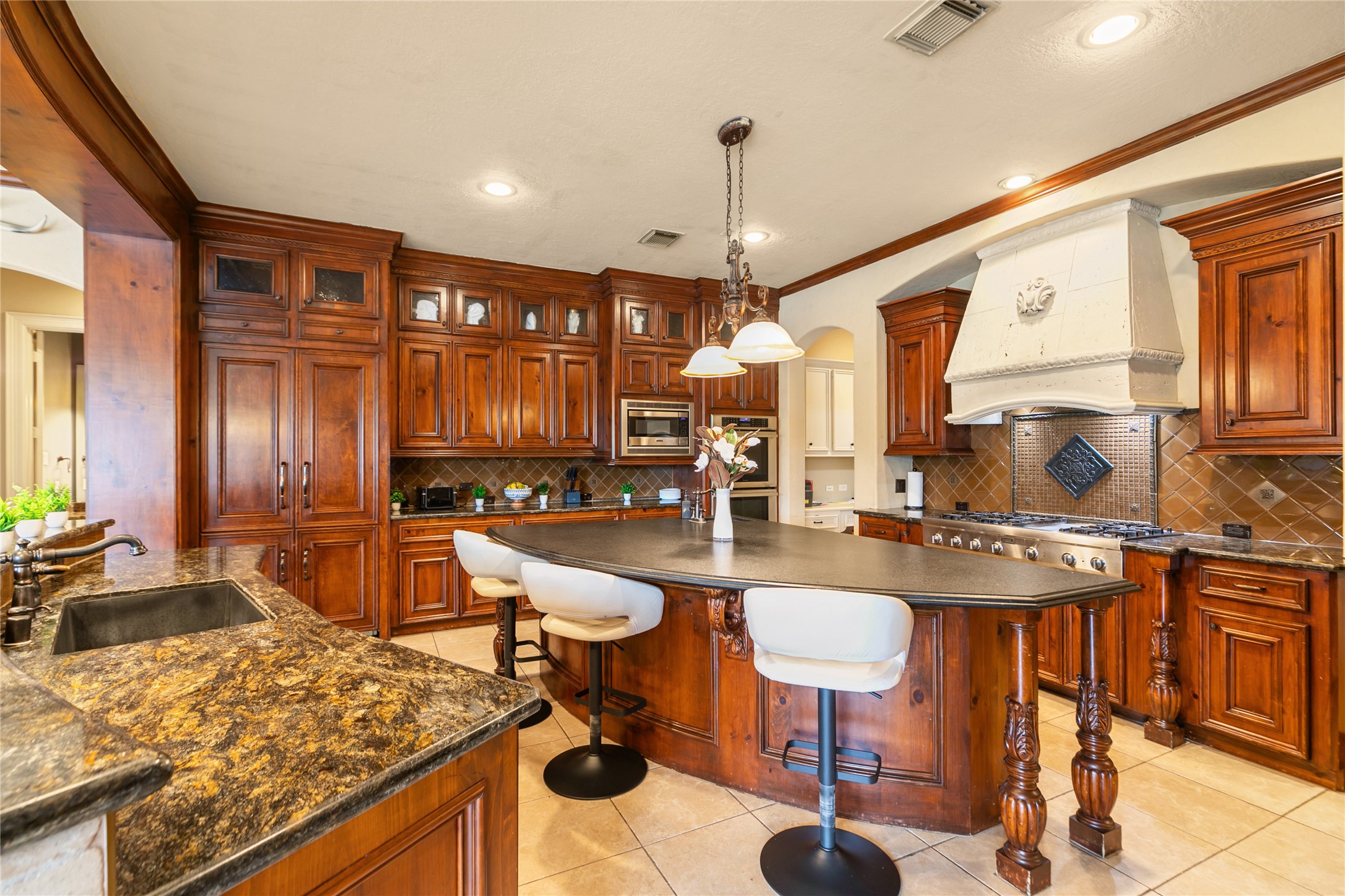 22 Post Shadow Estate Drive Spring, TX 77389 - Photo 29 of 50 a large kitchen with a table chairs stove and wooden floor