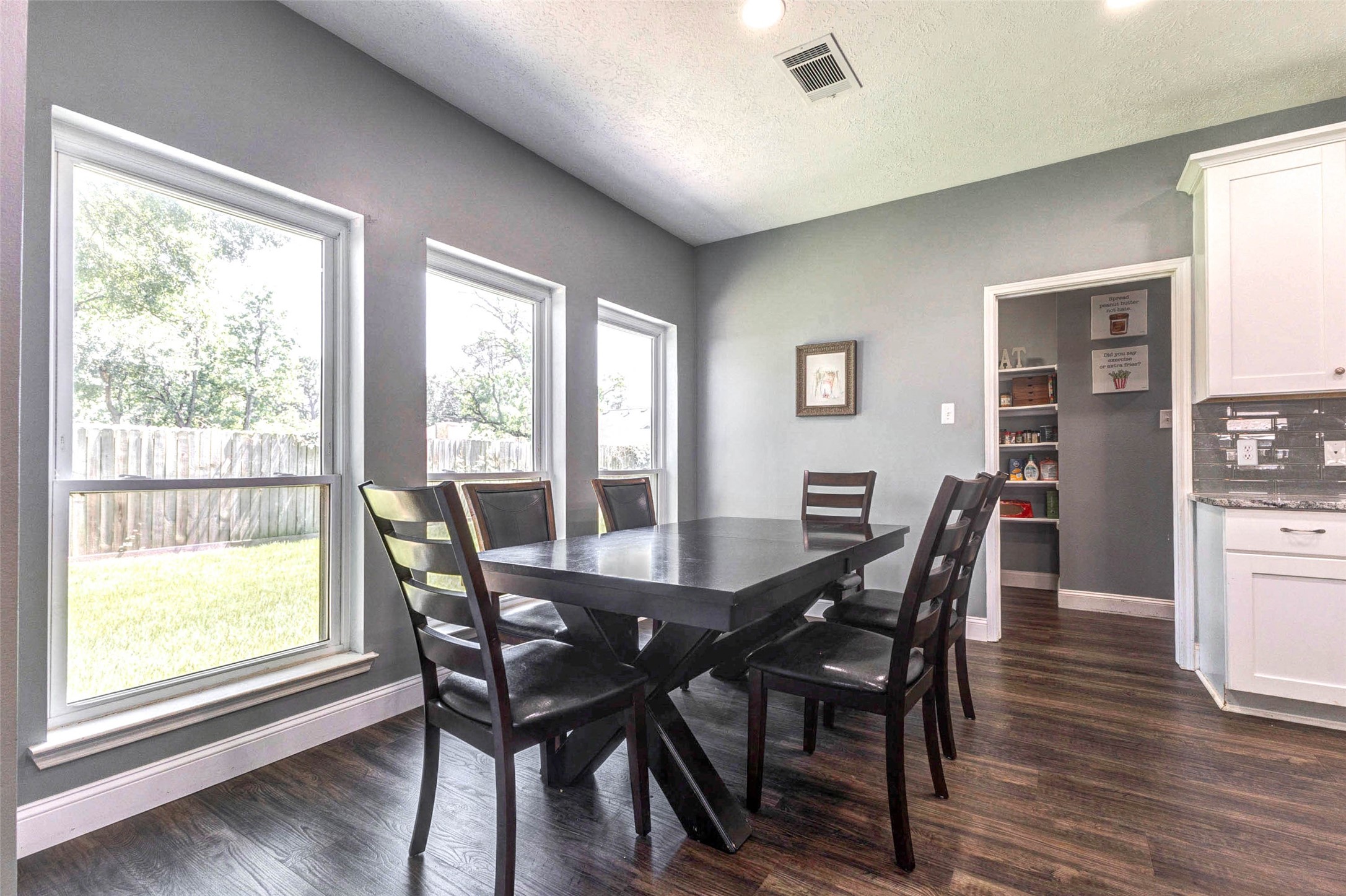 9215 Landry Boulevard Spring, TX 77379 - Photo 15 of 42 Three large windows overlook the backyard and fill the breakfast area with abundant natural light. Take note of the nearby pantry that offers convenient additional kitchen storage.