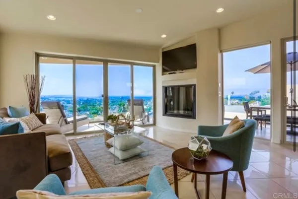 a living room with fireplace furniture and a large window