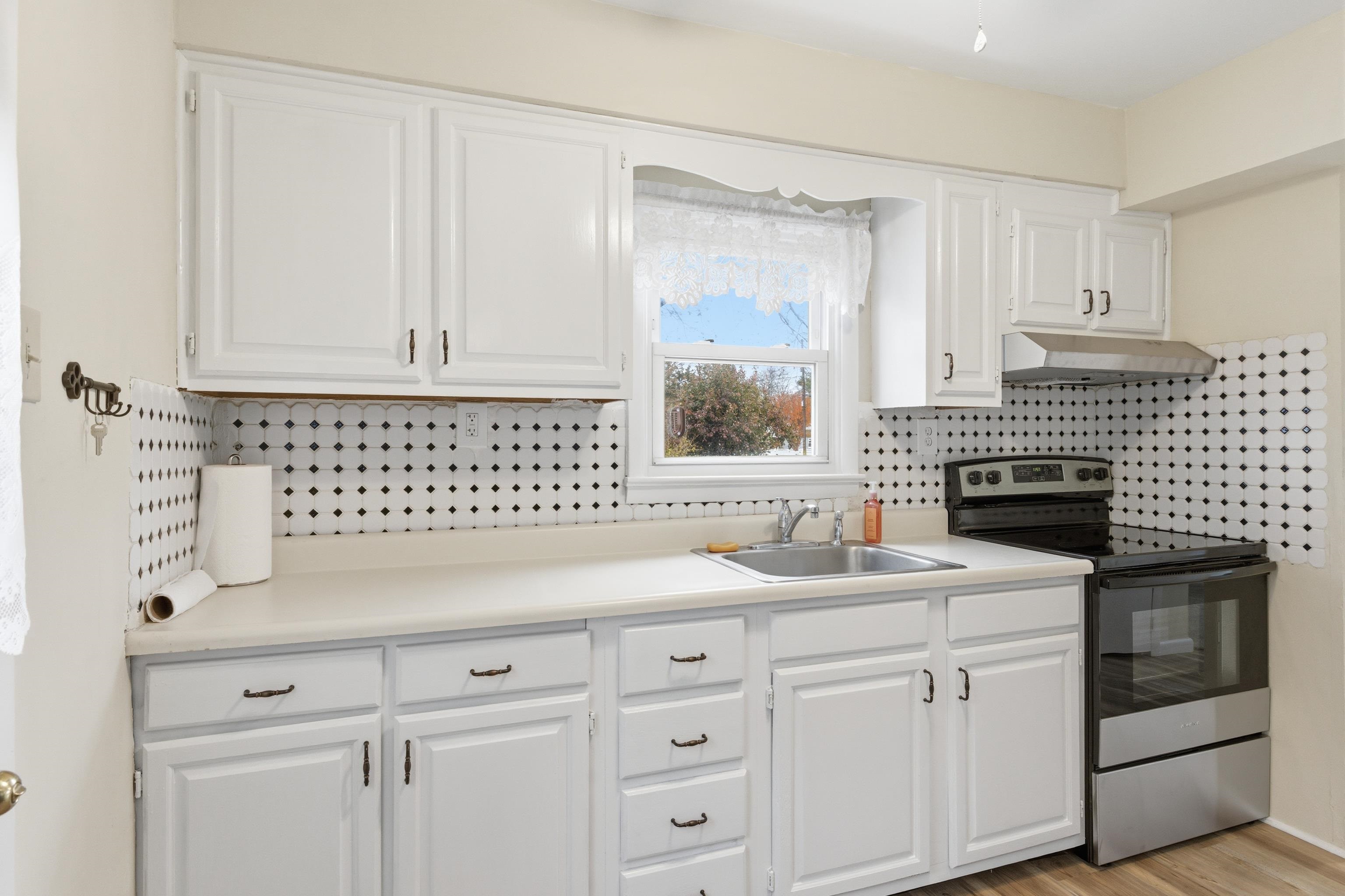 16 East Drumbed Road Villas, NJ 08251 - Photo 20 of 28 a kitchen with white cabinets and sink