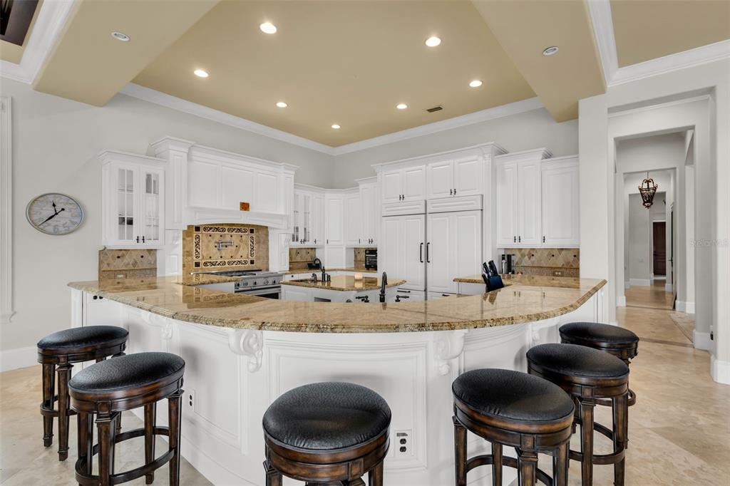 5417 Osprey Isle Lane Windermere, FL 34786 - Photo 11 of 45 a kitchen with kitchen island granite countertop wooden cabinets and stainless steel appliances