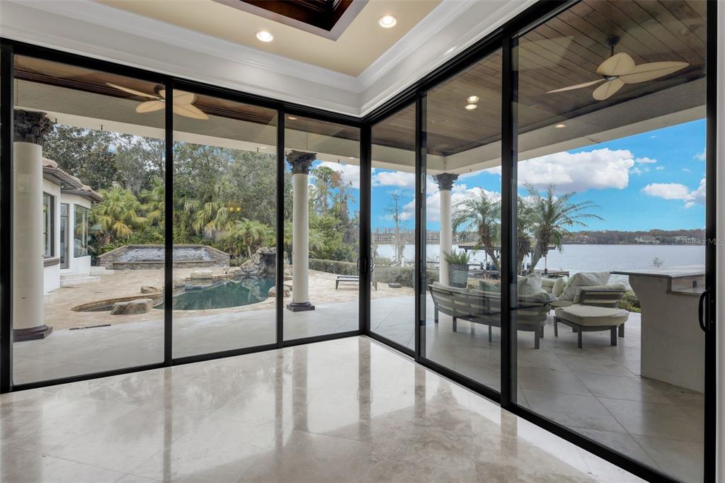 5417 Osprey Isle Lane Windermere, FL 34786 - Photo 16 of 45 a view of an empty room with large windows and a table
