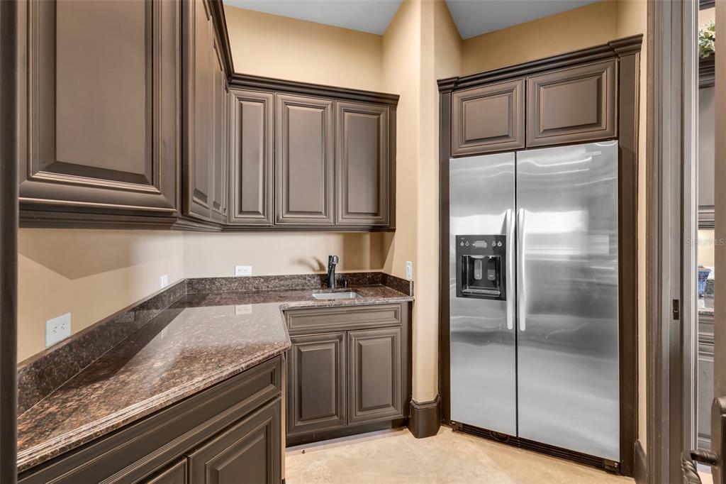 5417 Osprey Isle Lane Windermere, FL 34786 - Photo 21 of 45 a kitchen with stainless steel appliances granite countertop a refrigerator and a sink