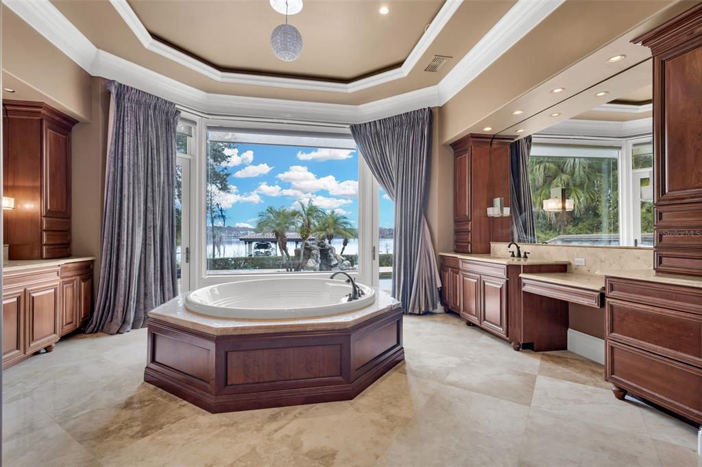 5417 Osprey Isle Lane Windermere, FL 34786 - Photo 31 of 45 a spacious bathroom with a tub sink a mirror and a shower