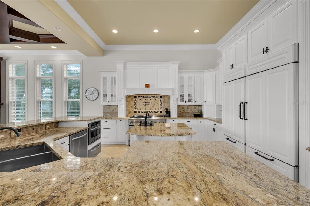 5417 Osprey Isle Lane Windermere, FL 34786 - Photo 33 of 45 a kitchen with stainless steel appliances granite countertop a stove and a sink