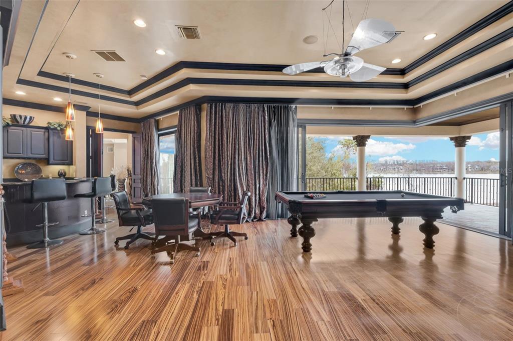 5417 Osprey Isle Lane Windermere, FL 34786 - Photo 34 of 45 a room with lots of furniture and wooden floor