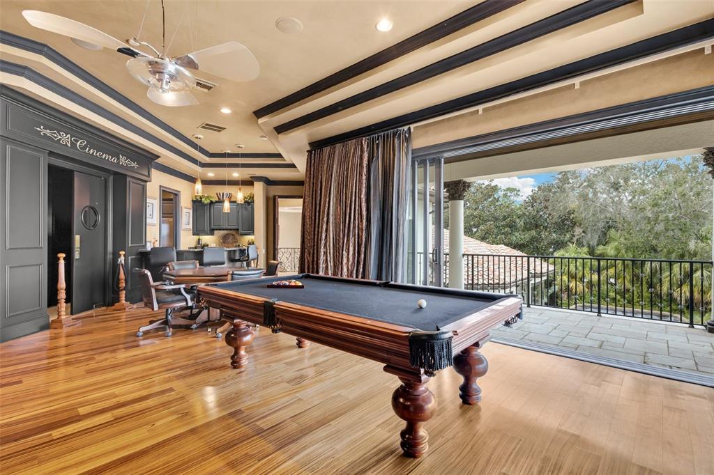 5417 Osprey Isle Lane Windermere, FL 34786 - Photo 35 of 45 a room with wooden floor pool table and windows