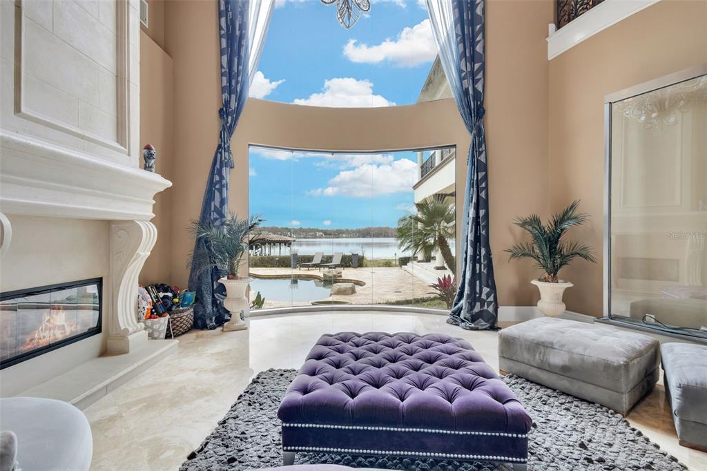 5417 Osprey Isle Lane Windermere, FL 34786 - Photo 6 of 45 a living room with a couch and a fireplace