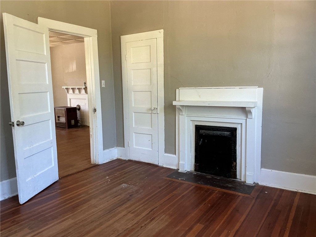 14 Ames Street Seneca, SC 29678 - Photo 6 of 15 This living area features a charming fireplace, rich hardwood floors, and bright trim work.
