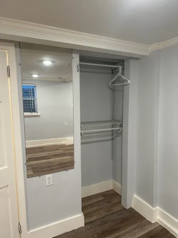 a view of walk in closet with empty racks