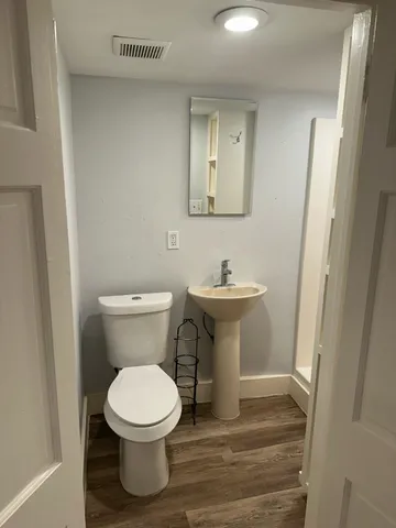 a white toilet sitting next to a bathroom sink