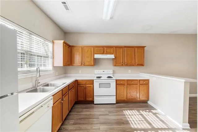a kitchen with stainless steel appliances granite countertop a sink stove and cabinets