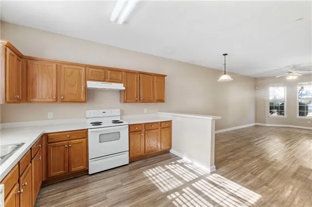 a kitchen with a sink stove and cabinets