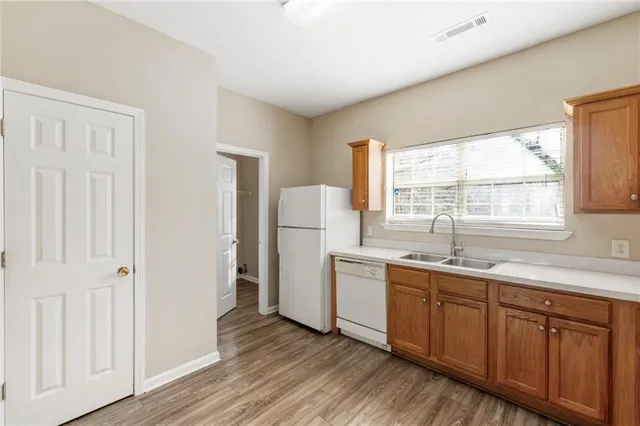 a kitchen with a sink a window and refrigerator