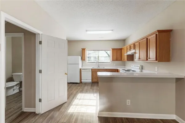 a kitchen with stainless steel appliances granite countertop a sink and cabinets