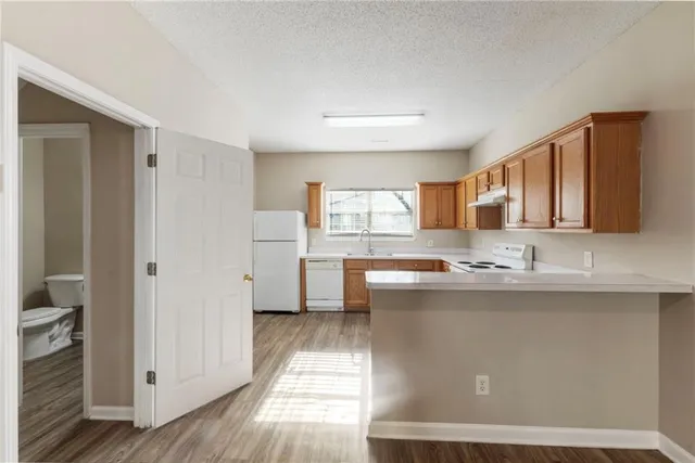 a kitchen with stainless steel appliances granite countertop a sink and cabinets