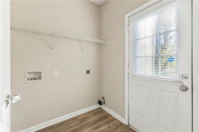 a view of a room with wooden floor and windows