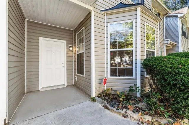 a view of a house with potted plants