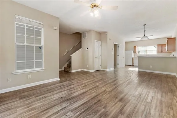 a view of empty room with wooden floor and window