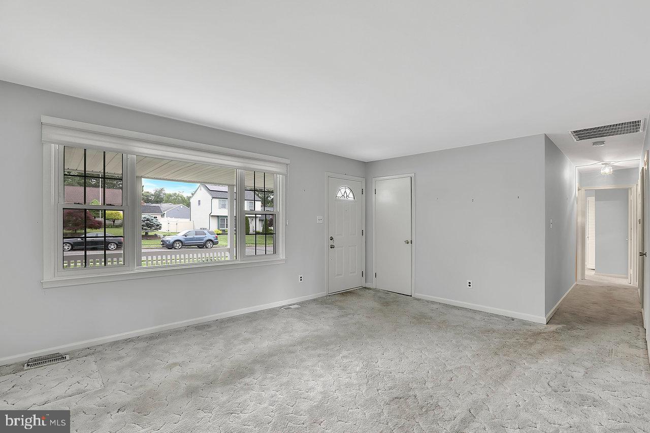 114 Pelham Road Delran, NJ 08075 - Photo 5 of 18 a view of a big room with windows and chandelier fan