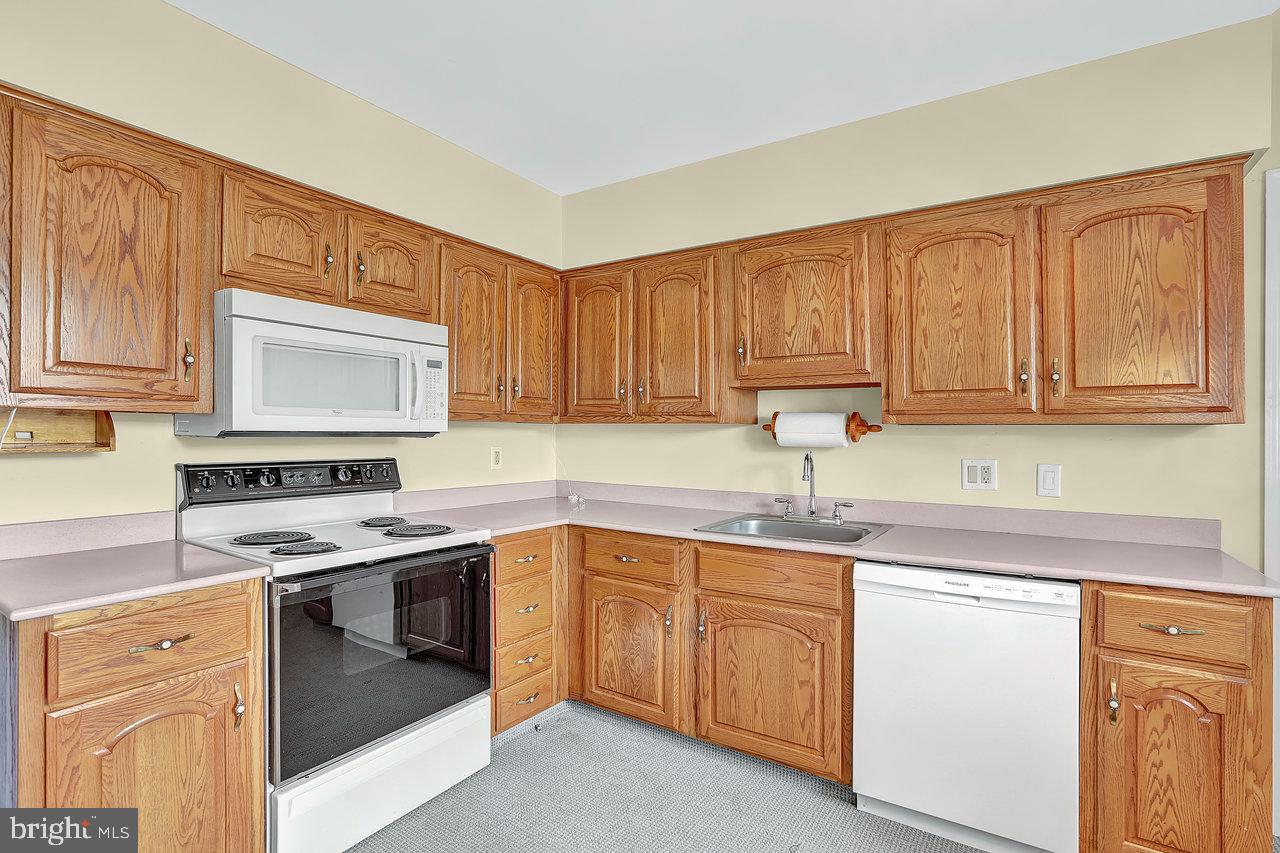 114 Pelham Road Delran, NJ 08075 - Photo 7 of 18 a kitchen with cabinets appliances a sink and a counter space