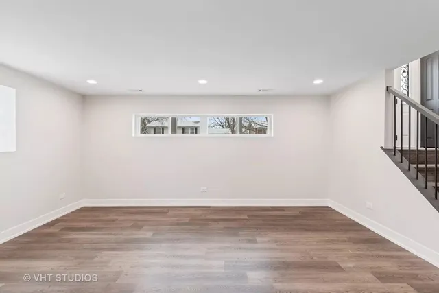 a view of a room with wooden floor