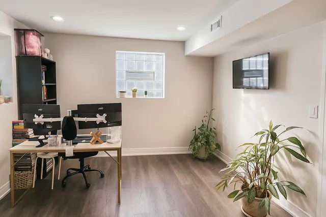 a workspace with furniture hardwood and a window