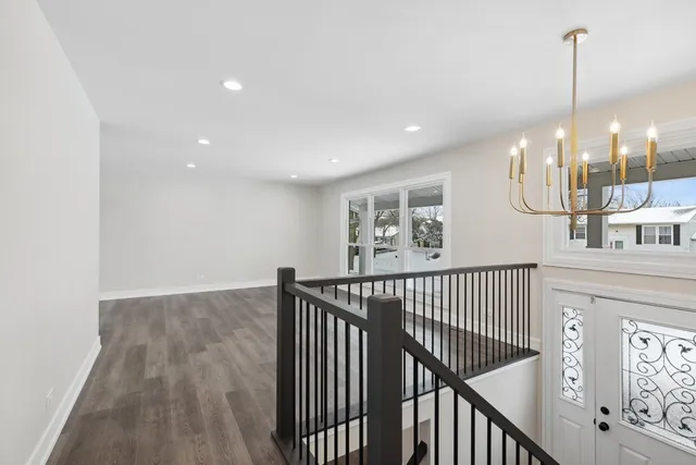 a view of staircase with wooden floor and windows