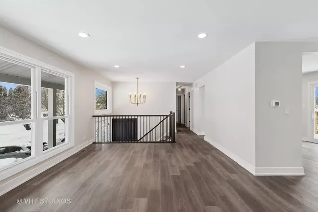 a view of a room with wooden floor and windows
