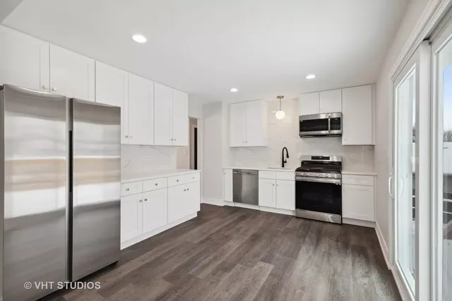 a kitchen with stainless steel appliances a refrigerator sink and stove