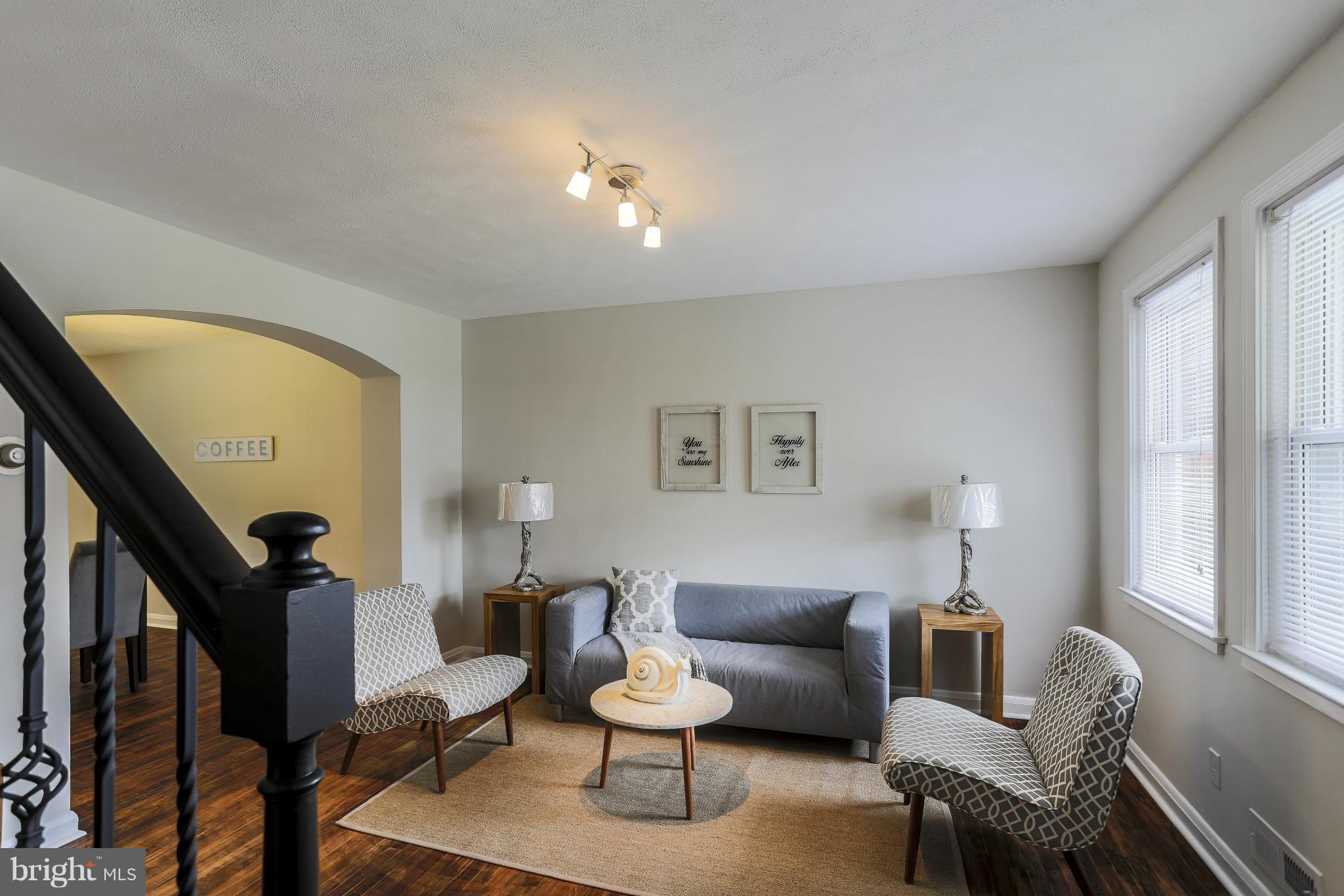 6923 Belclare Road Baltimore, MD 21222 - Photo 1 of 23 a living room with furniture and a lamp