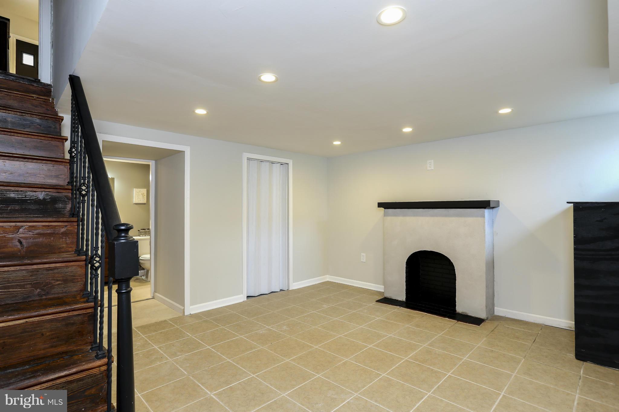 6923 Belclare Road Baltimore, MD 21222 - Photo 15 of 23 a view of an empty room with a fireplace