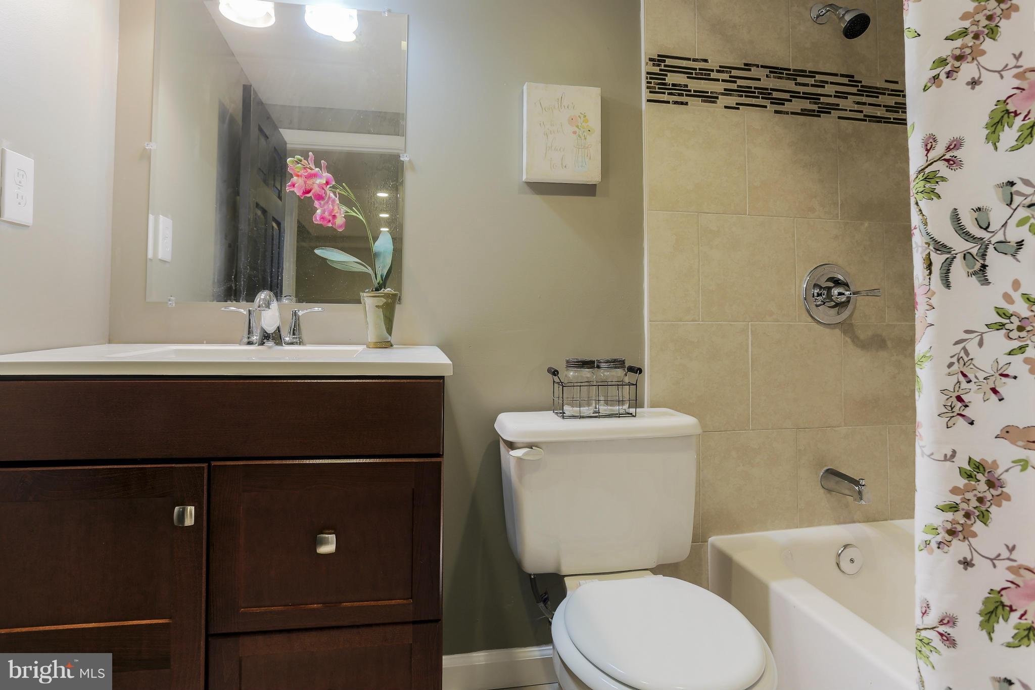 6923 Belclare Road Baltimore, MD 21222 - Photo 16 of 23 a bathroom with a sink toilet and shower