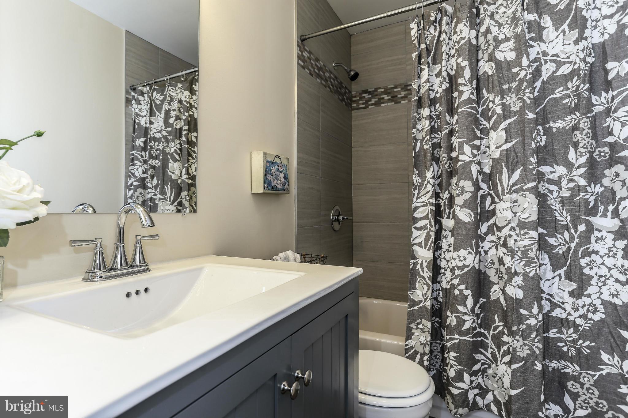 6923 Belclare Road Baltimore, MD 21222 - Photo 17 of 23 a bathroom with a sink toilet and shower